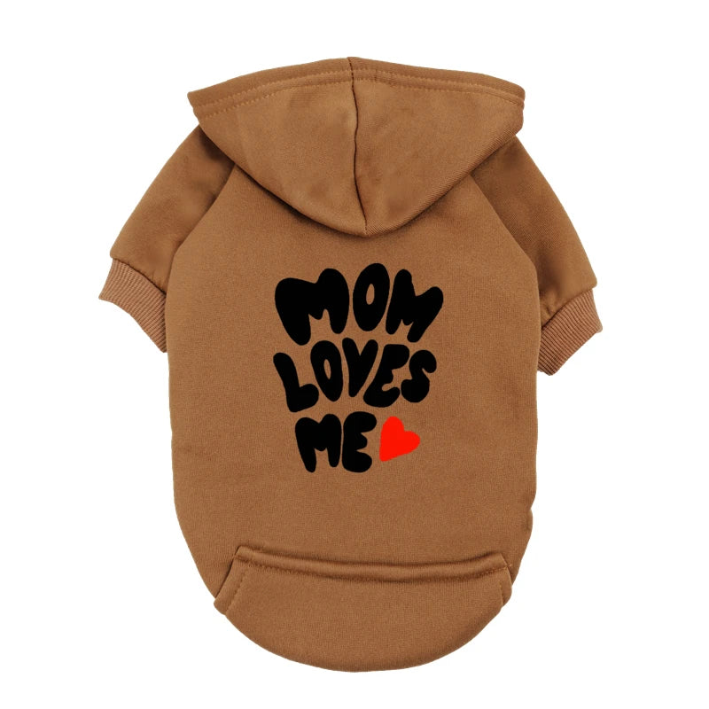 A delicate hoodie crafted for the most cherished pups, this piece wraps your dog in gentle warmth while adding a touch of everyday luxury.
The bold “Mom Loves Me” print and tiny red heart celebrate the special bond between you and your fur baby.