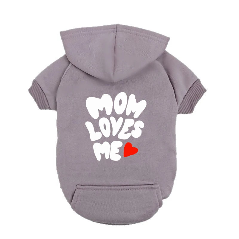 A delicate hoodie crafted for the most cherished pups, this piece wraps your dog in gentle warmth while adding a touch of everyday luxury.
The bold “Mom Loves Me” print and tiny red heart celebrate the special bond between you and your fur baby.