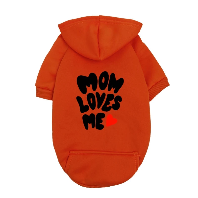 A delicate hoodie crafted for the most cherished pups, this piece wraps your dog in gentle warmth while adding a touch of everyday luxury.
The bold “Mom Loves Me” print and tiny red heart celebrate the special bond between you and your fur baby.