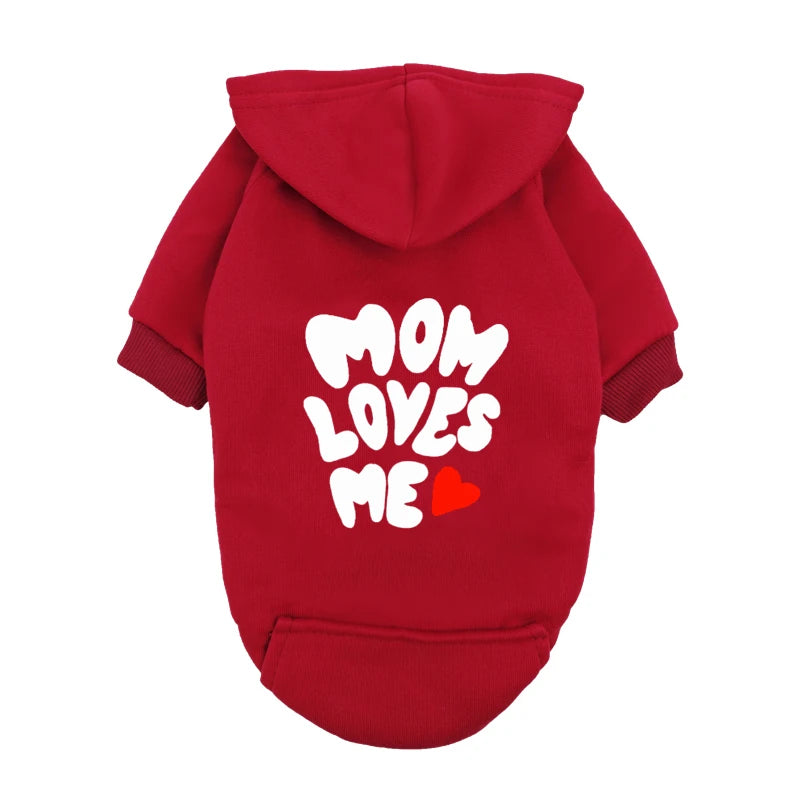 A delicate hoodie crafted for the most cherished pups, this piece wraps your dog in gentle warmth while adding a touch of everyday luxury.
The bold “Mom Loves Me” print and tiny red heart celebrate the special bond between you and your fur baby.