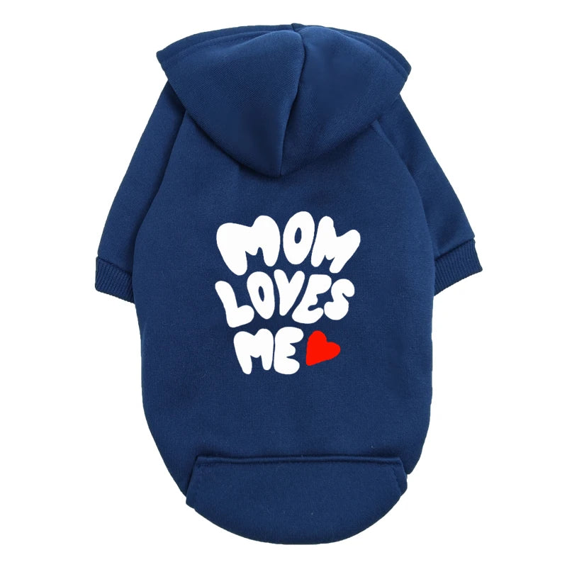 A delicate hoodie crafted for the most cherished pups, this piece wraps your dog in gentle warmth while adding a touch of everyday luxury.
The bold “Mom Loves Me” print and tiny red heart celebrate the special bond between you and your fur baby.