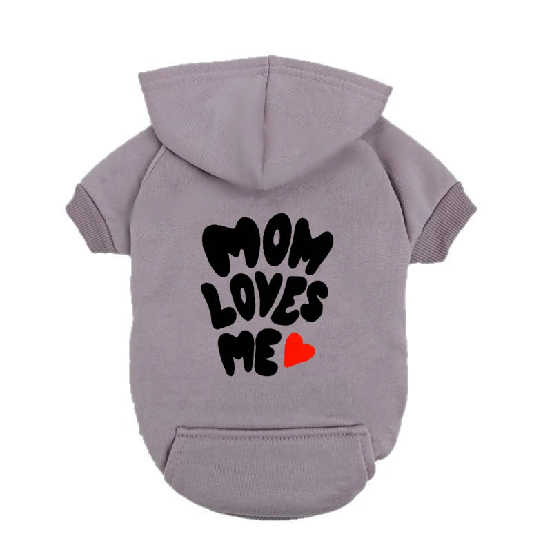 A delicate hoodie crafted for the most cherished pups, this piece wraps your dog in gentle warmth while adding a touch of everyday luxury.
The bold “Mom Loves Me” print and tiny red heart celebrate the special bond between you and your fur baby.