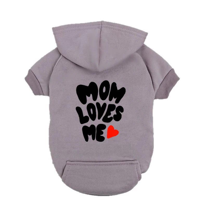 A delicate hoodie crafted for the most cherished pups, this piece wraps your dog in gentle warmth while adding a touch of everyday luxury. The bold “Mom Loves Me” print and tiny red heart celebrate the special bond between you and your fur baby. - Luxempirez