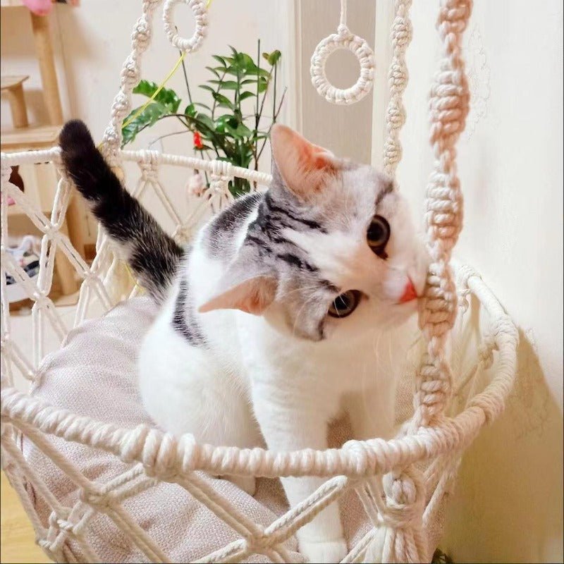 Give your feline a sanctuary in the sky with this hand‑woven luxury cat hammock, designed to float elegantly in your home like a piece of boho décor. The soft, suspended nest cradles your cat in complete comfort, while the exquisite macramé detailing. - Luxempirez