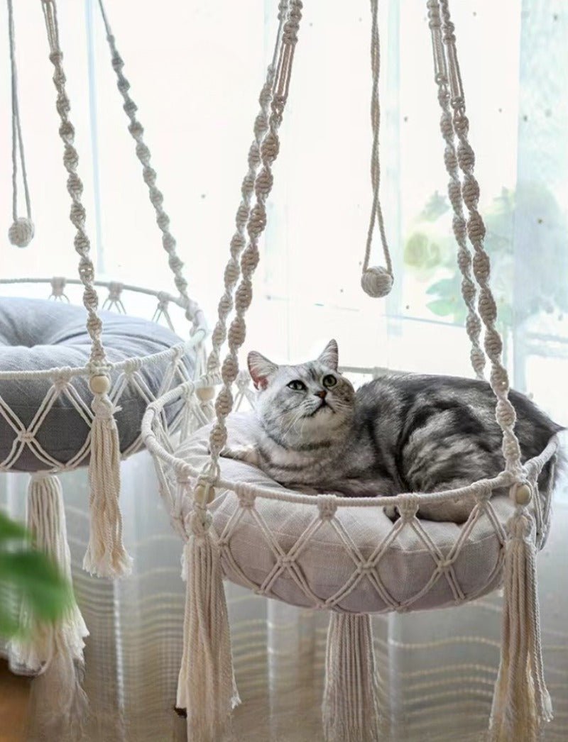 Give your feline a sanctuary in the sky with this hand‑woven luxury cat hammock, designed to float elegantly in your home like a piece of boho décor. The soft, suspended nest cradles your cat in complete comfort, while the exquisite macramé detailing. - Luxempirez